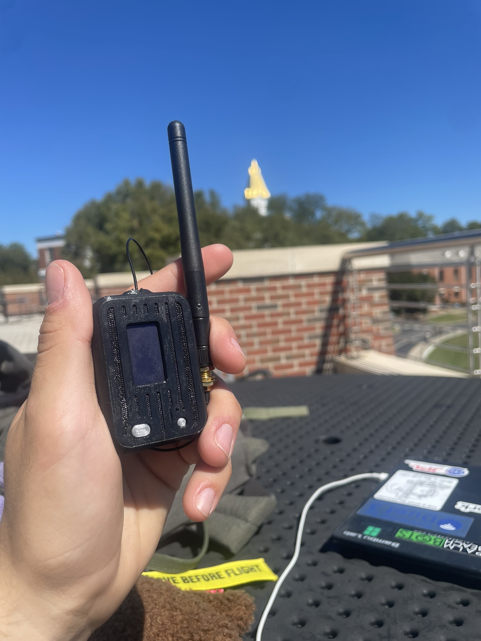 A handheld radio telemetry prototype being tested outdoors