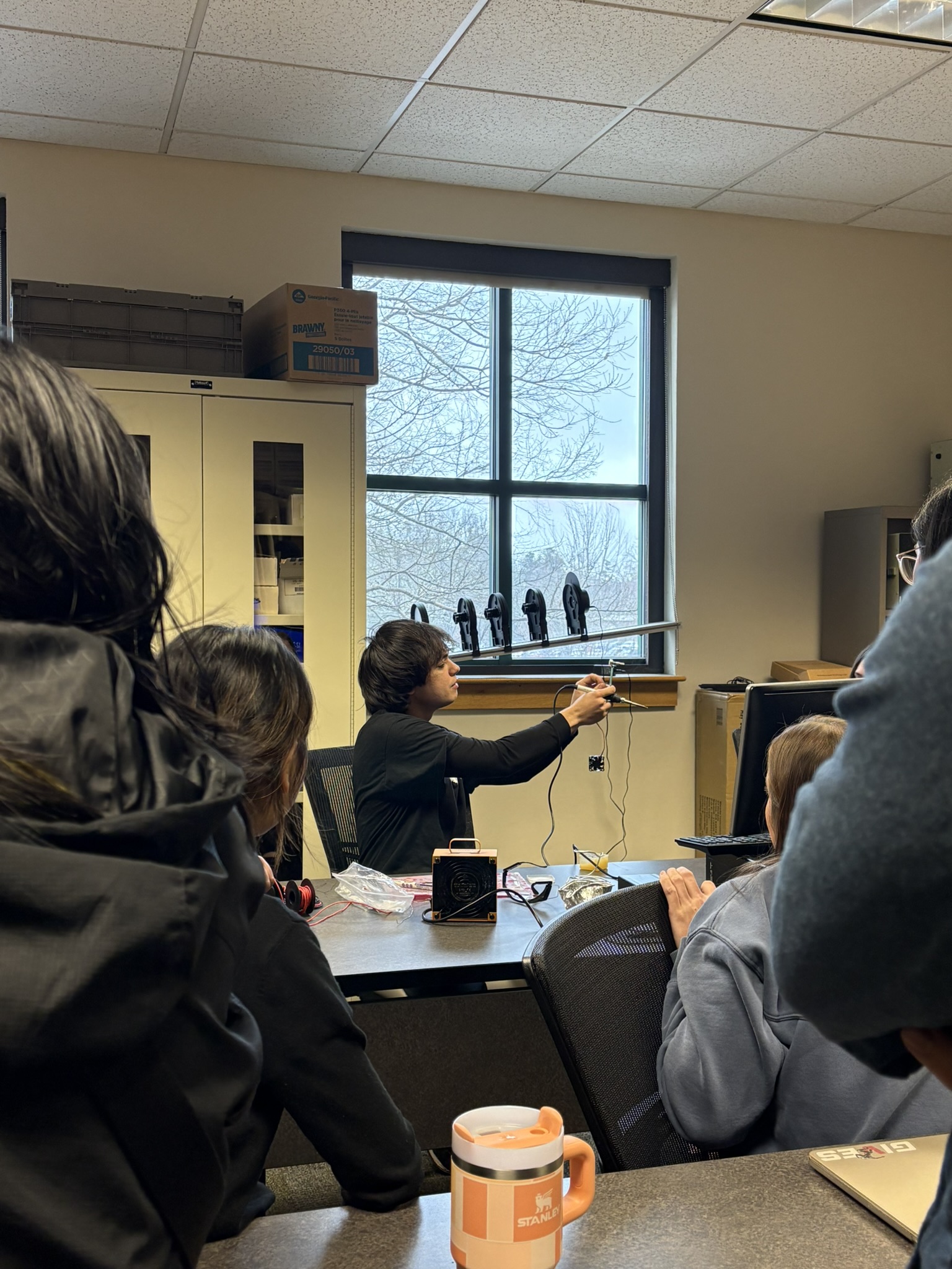 Jacob demonstrating an electronics project to a classroom